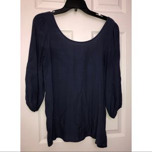 Women’s blue-ish shirt with open back with bow